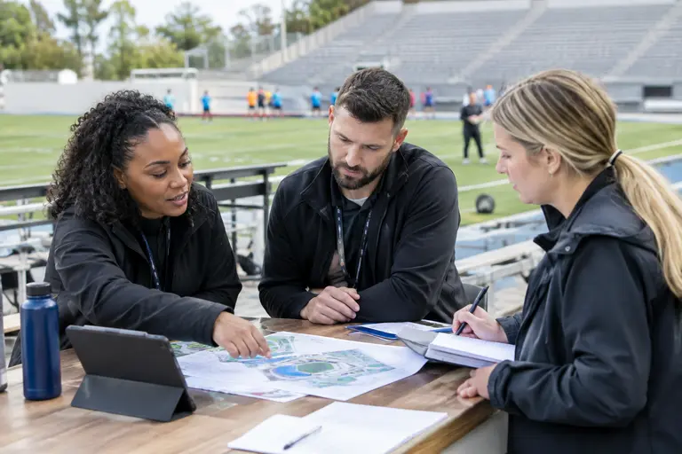 Venue planners reviewing access maps and event operations notes